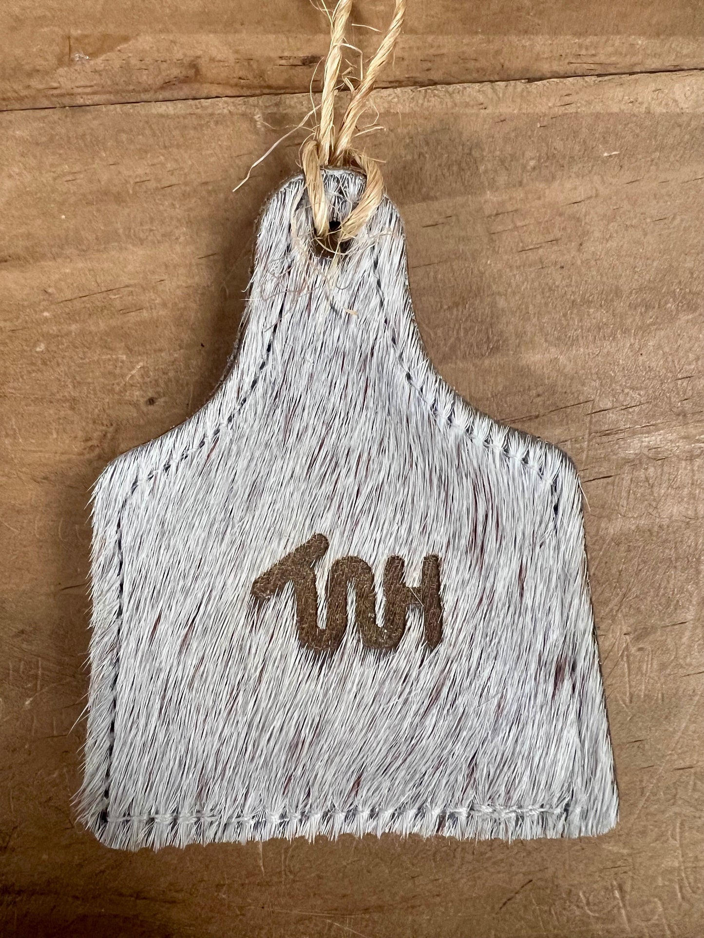 THE WHOLE HERD GIFTS Default COWHIDE EARTAG ORNAMENT